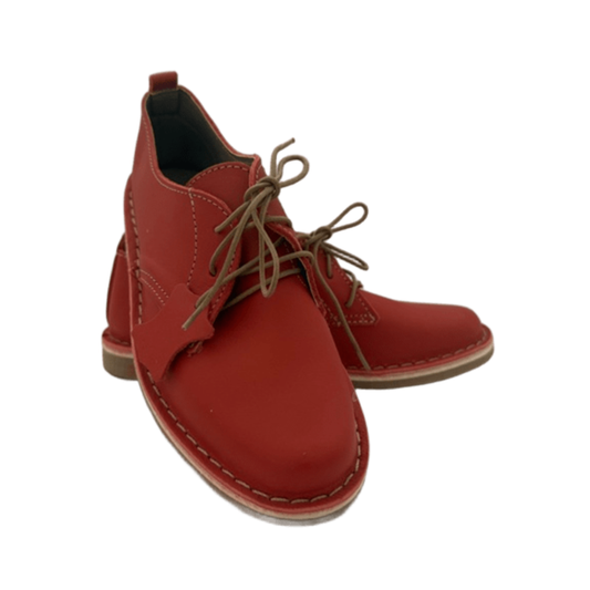 Red leather shoe with brown laces on a white background from the front