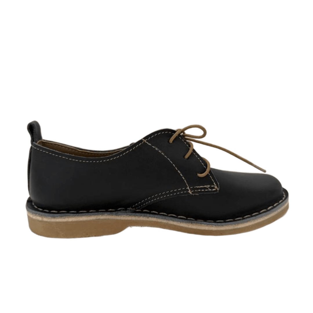Black leather shoe with brown laces on a white background from the side