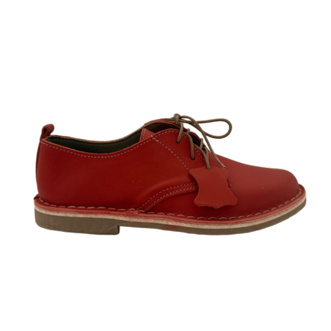 Red leather shoe on a white background from the side
