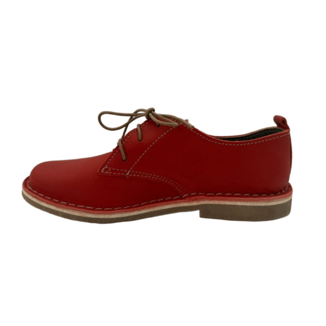 Red leather shoe on a white background from the side