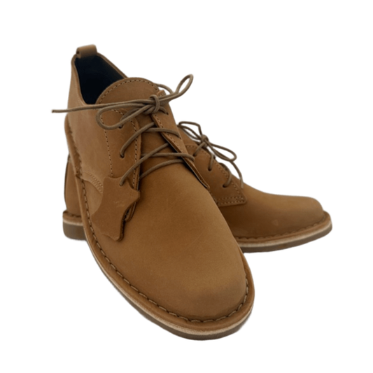 Pair of tan leather shoes on a white background from the front